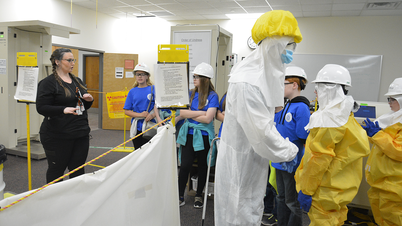 Chelsea Mullen, Grand Gulf radiation protection technician, explains to students from Bogue Chitto Attendance Center how she handles materials and keeps team members safe.